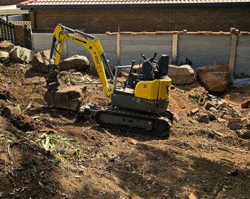 Top Shelf Earth Works excavator on a residential site